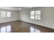 Bright bedroom with hardwood floors, a ceiling fan, and plenty of natural light at 4840 Pisgah Rd, Cumming, GA 30028