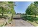 Gated entrance with a long driveway leading to the property surrounded by lush greenery at 4840 Pisgah Rd, Cumming, GA 30028