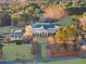 Grand aerial view of a three-story clubhouse with an expansive lawn and golf course in the background at 76 Telfair Ct, Acworth, GA 30101