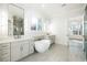 Elegant bathroom featuring a soaking tub, dual vanities, and modern lighting fixtures for a spa-like experience at 76 Telfair Ct, Acworth, GA 30101