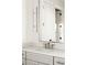 Bathroom sink and vanity with modern light fixture above and a glimpse into an adjacent room through the mirror at 76 Telfair Ct, Acworth, GA 30101