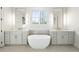 Elegant bathroom featuring a soaking tub, dual vanities, and modern lighting fixtures for a spa-like experience at 76 Telfair Ct, Acworth, GA 30101