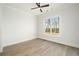 Bright bedroom featuring hardwood floors, a ceiling fan and large window offering scenic views at 76 Telfair Ct, Acworth, GA 30101