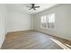Bright bedroom with two windows, ceiling fan, and neutral walls at 76 Telfair Ct, Acworth, GA 30101