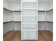 Spacious walk-in closet with built-in shelving and hanging rods, offering ample storage and organization options at 76 Telfair Ct, Acworth, GA 30101