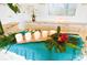 Beautiful centerpiece with candles, orchids, and tropical leaves on a kitchen counter at 76 Telfair Ct, Acworth, GA 30101