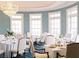 Bright dining room featuring elegant table settings, large windows, chandelier, and serene blue walls at 76 Telfair Ct, Acworth, GA 30101