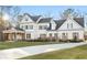 Stunning two-story home boasts white siding, gray shutters, and a charming covered porch with wooden pillars at 76 Telfair Ct, Acworth, GA 30101