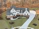 Stunning two-story home with a professionally landscaped front yard and a long concrete driveway at 76 Telfair Ct, Acworth, GA 30101