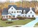 Beautiful two-story home boasts white siding, gray shutters, and a lovely front yard with mature trees at 76 Telfair Ct, Acworth, GA 30101