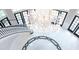 Grand foyer with marble floors, intricate black and white inlay, sweeping staircase, and stunning chandelier at 76 Telfair Ct, Acworth, GA 30101