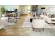 Comfortable living room featuring a sofa, chairs, bookshelves, and light hardwood flooring at 76 Telfair Ct, Acworth, GA 30101