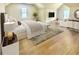 Large main bedroom with wood floors, TV, bedside tables and soft rug at 76 Telfair Ct, Acworth, GA 30101