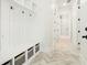 Well-organized mudroom with built-in storage, hooks, and herringbone floors at 76 Telfair Ct, Acworth, GA 30101