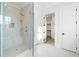 Modern shower with glass enclosure and sleek fixtures, complemented by neutral-toned tiles and a built-in niche at 76 Telfair Ct, Acworth, GA 30101