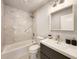 Updated bathroom showcasing marble style tile, shower and tub combo, and modern vanity at 1089 White Oak Sw Ave, Atlanta, GA 30310