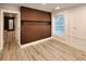Modern bedroom with large window for natural light, wainscotting, and dark brown accent wall at 1089 White Oak Sw Ave, Atlanta, GA 30310