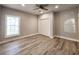 Neutral bedroom with large window, plank floors, and closet with bi-fold doors at 1089 White Oak Sw Ave, Atlanta, GA 30310