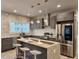 Modern kitchen features stainless steel appliances, gray cabinets, granite countertops, and island with seating at 1089 White Oak Sw Ave, Atlanta, GA 30310