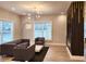 Comfortable living room area with stylish decor, modern lighting, and large windows for a bright atmosphere at 1089 White Oak Sw Ave, Atlanta, GA 30310