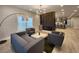 Inviting living area featuring sleek furniture, modern lighting, and an open layout connected to the kitchen at 1089 White Oak Sw Ave, Atlanta, GA 30310