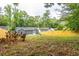 Spacious backyard with a view of the house and surrounding trees at 1699 Olympian Sw Way, Atlanta, GA 30310