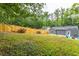 Sloped backyard with a view of the house and surrounding trees at 1699 Olympian Sw Way, Atlanta, GA 30310