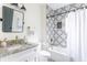 Updated bathroom with patterned tile, granite countertop, and bathtub at 1699 Olympian Sw Way, Atlanta, GA 30310