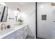 Modern bathroom with double vanity, frameless shower, and patterned floor at 1699 Olympian Sw Way, Atlanta, GA 30310