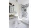 Stylish bathroom with patterned tile, granite vanity, and bathtub at 1699 Olympian Sw Way, Atlanta, GA 30310
