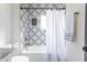 Clean bathroom with patterned tile, white bathtub, and shower at 1699 Olympian Sw Way, Atlanta, GA 30310