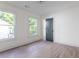 Bright bedroom with hardwood floors and two large windows at 1699 Olympian Sw Way, Atlanta, GA 30310