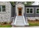 Stylish front entry with modern wooden door and white steps at 1699 Olympian Sw Way, Atlanta, GA 30310