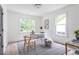 Bright home office features hardwood floors, a white desk, and two large windows at 1699 Olympian Sw Way, Atlanta, GA 30310