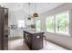 Modern kitchen with stainless steel appliances, granite island, and white shaker cabinets at 1699 Olympian Sw Way, Atlanta, GA 30310