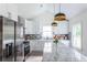 Modern kitchen with stainless steel appliances, granite island, and white shaker cabinets at 1699 Olympian Sw Way, Atlanta, GA 30310