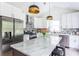 Modern kitchen with stainless steel appliances, granite island, and white shaker cabinets at 1699 Olympian Sw Way, Atlanta, GA 30310