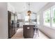 Modern kitchen with stainless steel appliances, granite island, and white shaker cabinets at 1699 Olympian Sw Way, Atlanta, GA 30310