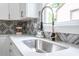 Modern kitchen sink and faucet with white quartz countertops at 1699 Olympian Sw Way, Atlanta, GA 30310