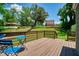 Back deck with wooden railing, blue metal chairs, and a view of the wooded backyard at 3182 Lake Ave, Atlanta, GA 30354