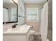 Bathroom featuring white marble countertops, a tiled shower, and a framed mirror at 3182 Lake Ave, Atlanta, GA 30354