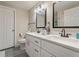 Bathroom featuring double vanity with white cabinets and modern fixtures with grey tile floor at 3182 Lake Ave, Atlanta, GA 30354