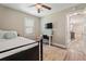 Bedroom with a TV, ceiling fan, desk, and doorway that leads to the kitchen at 3182 Lake Ave, Atlanta, GA 30354
