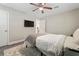 Relaxing bedroom features plush bedding, modern ceiling fan, and hardwood floors at 3182 Lake Ave, Atlanta, GA 30354