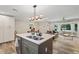 Modern open-concept kitchen with stainless steel appliances and quartz countertops flows to the living area at 3182 Lake Ave, Atlanta, GA 30354