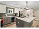 Stylish kitchen featuring stainless steel appliances, tile backsplash, and a gray kitchen island with a quartz countertop at 3182 Lake Ave, Atlanta, GA 30354