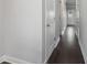 Hallway with rich hardwood floors, white walls, and a view of the entrance door at 3136-A Brownstone Se Ln, Atlanta, GA 30354