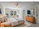 Bright main bedroom featuring a ceiling fan, large window, and an ensuite bathroom at 3136-A Brownstone Se Ln, Atlanta, GA 30354