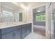 Elegant bathroom featuring double vanity, spacious mirror and an open doorway to the bedrom at 376 Lakeside Ct, Canton, GA 30114