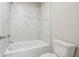 Bright bathroom with white marble tiling, tub, and shower at 376 Lakeside Ct, Canton, GA 30114